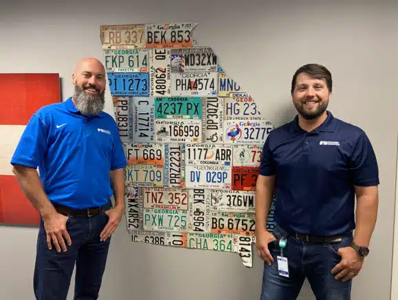 Trooper Smith and Josh Starling in front of a Georgia decoration