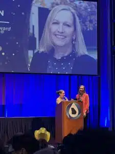 Photograph of Freese and Nichols account director Paula Feldman, right, receiving the Georgia Association of Water Professionals President's Award from outgoing GAWP president Kathy Nguyen, left. 