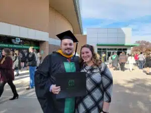 Image of Miguel Rivera and his wife at his graduation from UNT